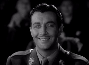 Movie still from “Waterloo Bridge” (1940), directed by Mervyn LeRoy – A black and white photo of a man in military uniform; Close Up shot, Low angle