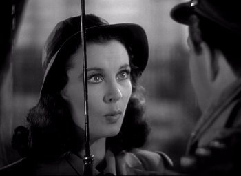 Movie still from “Waterloo Bridge” (1940), directed by Mervyn LeRoy – A black - and - white photo of a woman holding a cane; Close Up shot, Over the shoulder angle