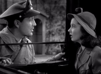 Movie still from “Waterloo Bridge” (1940), directed by Mervyn LeRoy – A man and a woman are looking at each other; Close Up shot, Over the shoulder angle