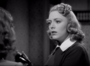 Movie still from “Waterloo Bridge” (1940), directed by Mervyn LeRoy – A black and white photo of a woman with a hair brush; Close Up shot, Over the shoulder angle