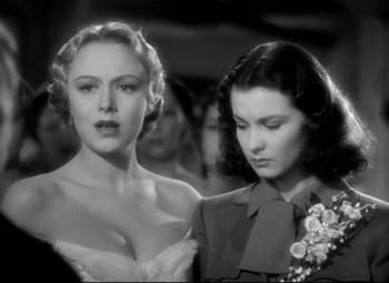 Movie still from “Waterloo Bridge” (1940), directed by Mervyn LeRoy – Two beautiful women standing next to each other in a crowd; Close Up shot, Low angle