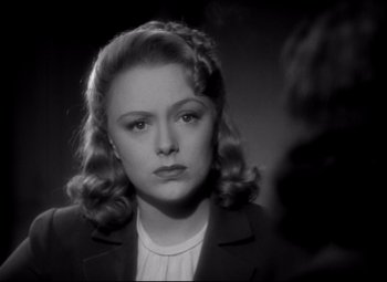 Movie still from “Waterloo Bridge” (1940), directed by Mervyn LeRoy – A black - and - white photo of a woman in a suit; Close Up shot, Over the shoulder angle
