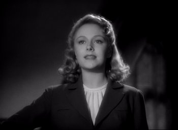 Movie still from “Waterloo Bridge” (1940), directed by Mervyn LeRoy – A black and white photo of a woman in a suit; Close Up shot, Low angle