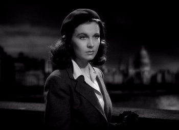 Movie still from “Waterloo Bridge” (1940), directed by Mervyn LeRoy – A woman in a black and white photo wearing a hat; Close Up shot, Low angle