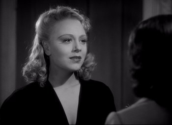 Movie still from “Waterloo Bridge” (1940), directed by Mervyn LeRoy – A black - and - white photo of a woman talking to another woman; Close Up shot, Over the shoulder angle