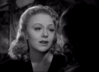 Movie still from “Waterloo Bridge” (1940), directed by Mervyn LeRoy – An old photo of a woman with blonde hair; Close Up shot, Over the shoulder angle