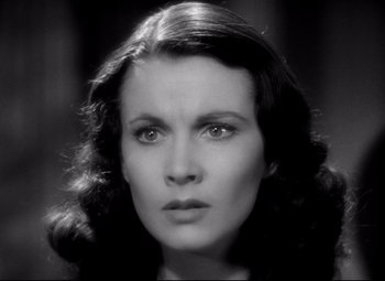 Movie still from “Waterloo Bridge” (1940), directed by Mervyn LeRoy – An old photo of a beautiful woman with long dark hair; Close Up shot, High angle