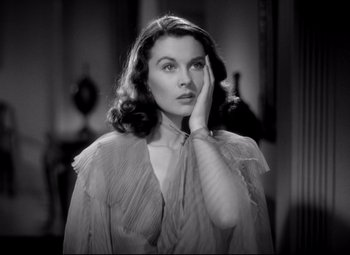 Movie still from “Waterloo Bridge” (1940), directed by Mervyn LeRoy – A black - and - white photo of a woman in a dress; Close Up shot, Low angle