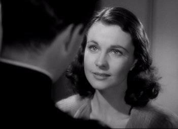 Movie still from “Waterloo Bridge” (1940), directed by Mervyn LeRoy – A woman looking at a man in a mirror; Close Up shot, Over the shoulder angle