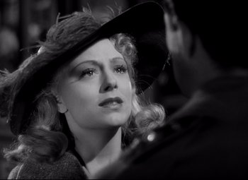 Movie still from “Waterloo Bridge” (1940), directed by Mervyn LeRoy – A black and white photo of a woman in a hat; Close Up shot, Over the shoulder angle