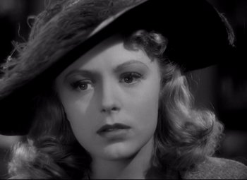 Movie still from “Waterloo Bridge” (1940), directed by Mervyn LeRoy – A black and white photo of a woman in a hat; Close Up shot, High angle