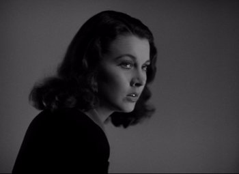 Movie still from “Waterloo Bridge” (1940), directed by Mervyn LeRoy – A black - and - white photo of a woman in a black shirt; Close Up shot, Low angle