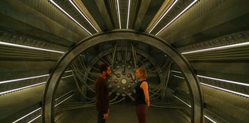 Movie still from “Another Life” (2019), created by Aaron Martin – A man and a woman standing next to each other; Wide shot, High angle