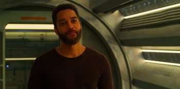 Movie still from “Another Life” (2019), created by Aaron Martin – A man with a beard is looking at the camera; Close Up shot, Over the shoulder angle