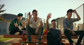 Movie still from “We Are Your Friends” (2015), directed by Max Joseph – A group of young men sitting on top of a wooden bench; Wide shot, Low angle