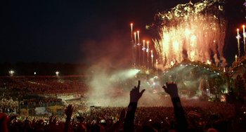 Movie still from “We Are Your Friends” (2015), directed by Max Joseph – A crowd of people at a fireworks show at night; Extreme Wide shot, High angle