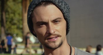 Movie still from “We Are Your Friends” (2015), directed by Max Joseph – A person wearing a hat; Close Up shot, Over the shoulder angle