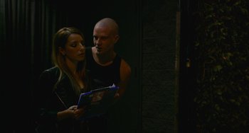 Movie still from “We Are Your Friends” (2015), directed by Max Joseph – A man and a woman are looking at a book; Medium shot, Over the shoulder angle