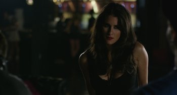 Movie still from “We Are Your Friends” (2015), directed by Max Joseph – A beautiful woman with long brown hair wearing a black top; Close Up shot, Over the shoulder angle