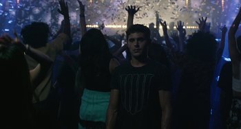 Movie still from “We Are Your Friends” (2015), directed by Max Joseph – A man standing in front of a group of people; Medium shot, Over the shoulder angle