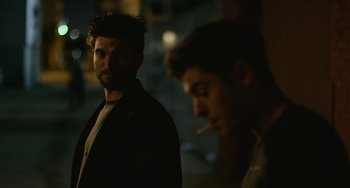 Movie still from “We Are Your Friends” (2015), directed by Max Joseph – A man standing next to another man smoking a cigarette; Close Up shot, Over the shoulder angle