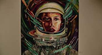 Movie still from “We Are Your Friends” (2015), directed by Max Joseph – A painting of a woman wearing a space suit; Medium shot, Overhead angle