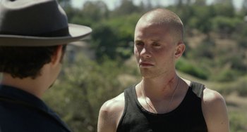 Movie still from “We Are Your Friends” (2015), directed by Max Joseph – A man with a shaved head is talking to another man; Close Up shot, Over the shoulder angle