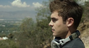 Movie still from “We Are Your Friends” (2015), directed by Max Joseph – A young man wearing headphones looking off into the distance; Close Up shot, Over the shoulder angle