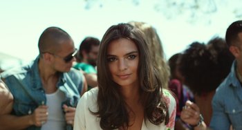 Movie still from “We Are Your Friends” (2015), directed by Max Joseph – A beautiful woman with long brown hair standing in front of a crowd of onlookers; Close Up shot, Low angle