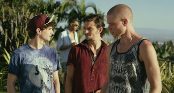 Movie still from “We Are Your Friends” (2015), directed by Max Joseph – A group of young men standing next to each other on a beach; Medium shot, Over the shoulder angle