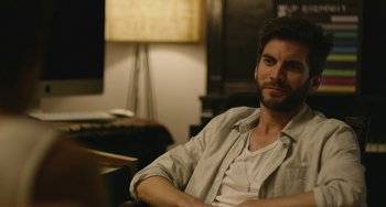 Movie still from “We Are Your Friends” (2015), directed by Max Joseph – A person sitting in a chair in a room; Close Up shot, Over the shoulder angle