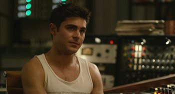 Movie still from “We Are Your Friends” (2015), directed by Max Joseph – A man in a white tank top sitting in front of a microphone; Close Up shot, Over the shoulder angle