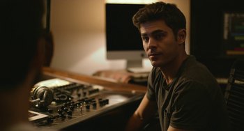 Movie still from “We Are Your Friends” (2015), directed by Max Joseph – A man sitting in front of a sound board; Close Up shot, Over the shoulder angle