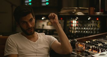 Movie still from “We Are Your Friends” (2015), directed by Max Joseph – A man sitting at a table with a glass of whiskey; Close Up shot, Over the shoulder angle