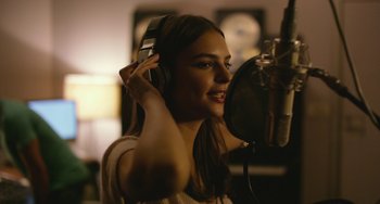 Movie still from “We Are Your Friends” (2015), directed by Max Joseph – A woman with a microphone in a recording studio; Close Up shot, High angle