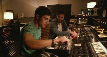 Movie still from “We Are Your Friends” (2015), directed by Max Joseph – Two men working in a recording studio on a mixing board; Medium shot, High angle