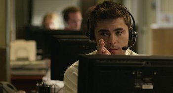 Movie still from “We Are Your Friends” (2015), directed by Max Joseph – A man wearing a headset looking at a computer screen; Close Up shot, High angle