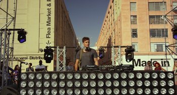 Movie still from “We Are Your Friends” (2015), directed by Max Joseph – A man standing in front of a dj booth; Wide shot, Low angle