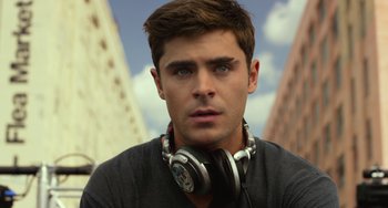 Movie still from “We Are Your Friends” (2015), directed by Max Joseph – A man with headphones is looking into the camera; Close Up shot, Low angle