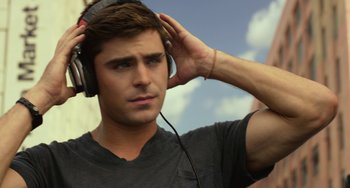 Movie still from “We Are Your Friends” (2015), directed by Max Joseph – A man with a beard is listening to some music; Close Up shot, Low angle