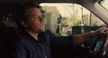 Movie still from “We Bought a Zoo” (2011), directed by Cameron Crowe – A man sitting in the back of a car looking out the window; Close Up shot, Over the shoulder angle