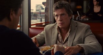 Movie still from “We Bought a Zoo” (2011), directed by Cameron Crowe – A man sitting in front of a plate of food; Close Up shot, Over the shoulder angle