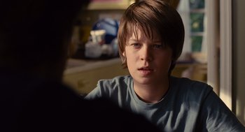 Movie still from “We Bought a Zoo” (2011), directed by Cameron Crowe – A young boy sitting in front of a mirror; Close Up shot, Over the shoulder angle