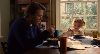 Movie still from “We Bought a Zoo” (2011), directed by Cameron Crowe – A man sitting at a table with a little girl eating cake; Medium shot, Over the shoulder angle