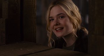 Movie still from “We Bought a Zoo” (2011), directed by Cameron Crowe – A young girl smiling for the camera while sitting on a bench; Close Up shot, Over the shoulder angle