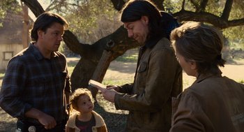 Movie still from “We Bought a Zoo” (2011), directed by Cameron Crowe – A group of people standing in a park with trees; Medium shot, Over the shoulder angle