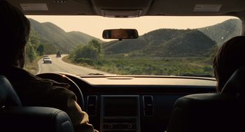 Movie still from “We Bought a Zoo” (2011), directed by Cameron Crowe – A view from inside a car looking out the windshield; Wide shot, Over the shoulder angle