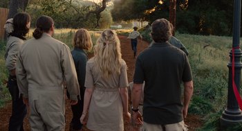 Movie still from “We Bought a Zoo” (2011), directed by Cameron Crowe – A group of people walking down a dirt road; Wide shot, Over the shoulder angle