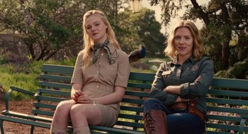 Movie still from “We Bought a Zoo” (2011), directed by Cameron Crowe – Two women sitting on a park bench with a bird in the background; Medium shot, Over the shoulder angle