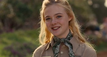 Movie still from “We Bought a Zoo” (2011), directed by Cameron Crowe – A young woman wearing a brown shirt and a neck tie; Close Up shot, High angle